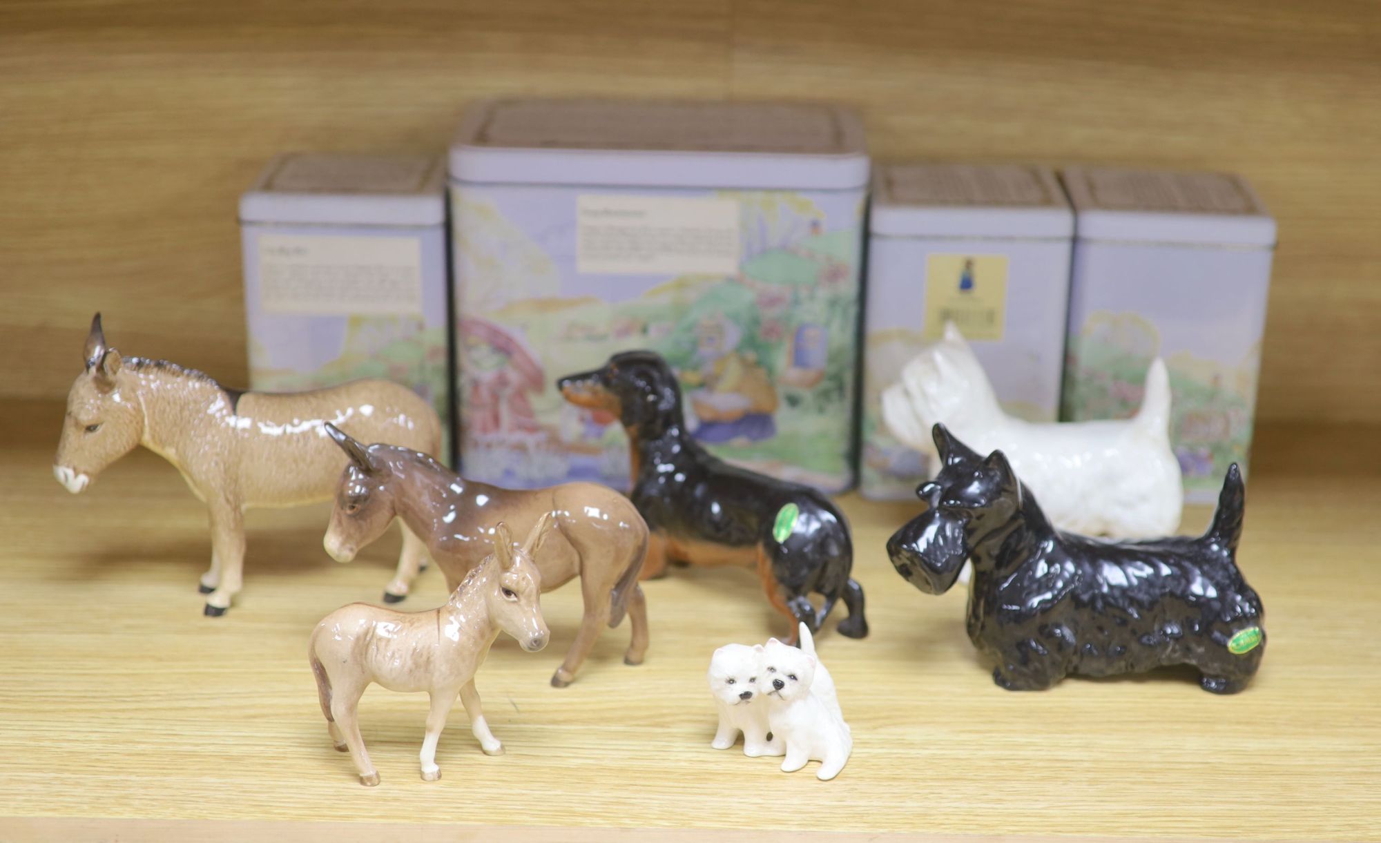 Three Beswick donkeys and four dogs, and four Tales of Honeysuckle Hill figures, tallest 13cm